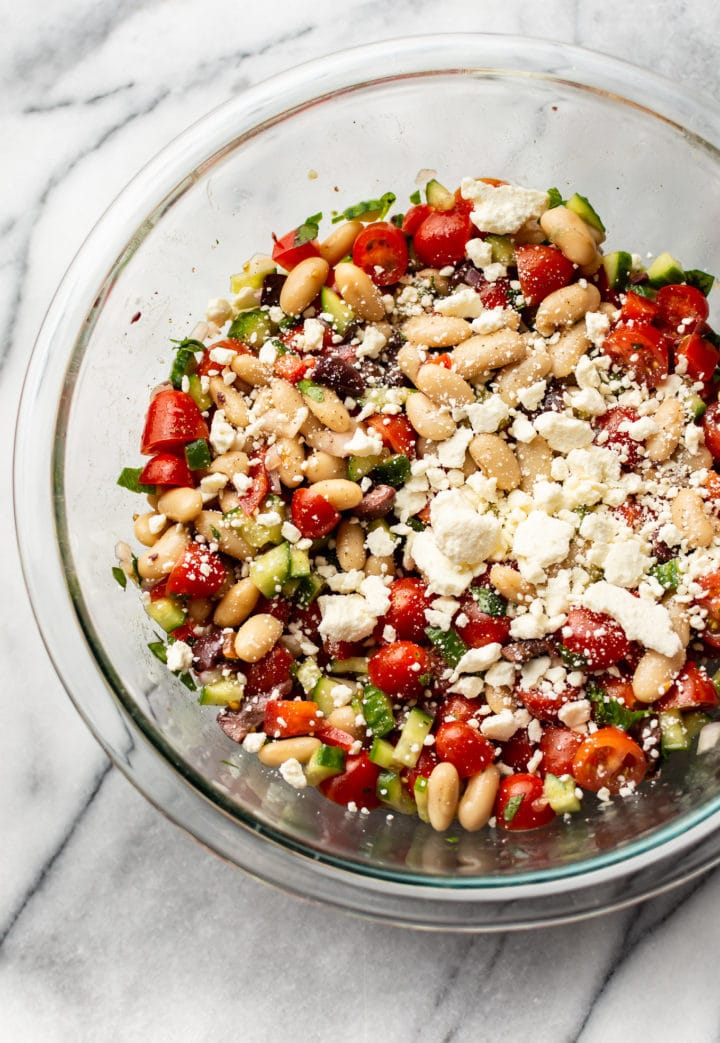 Greek white bean salad in a glass bowl