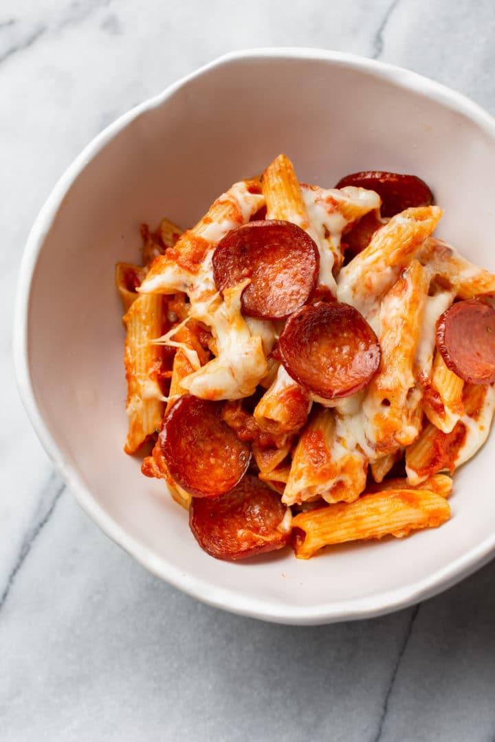 pizza pasta bake in a white bowl