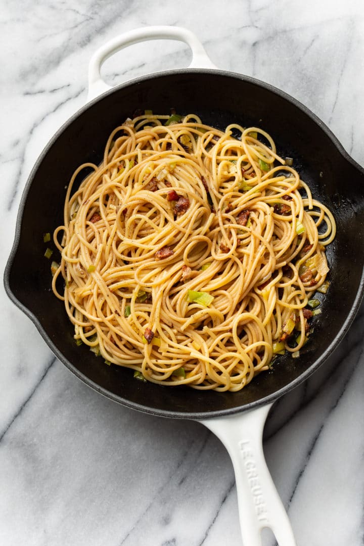 bacon and leek spaghetti in a skillet