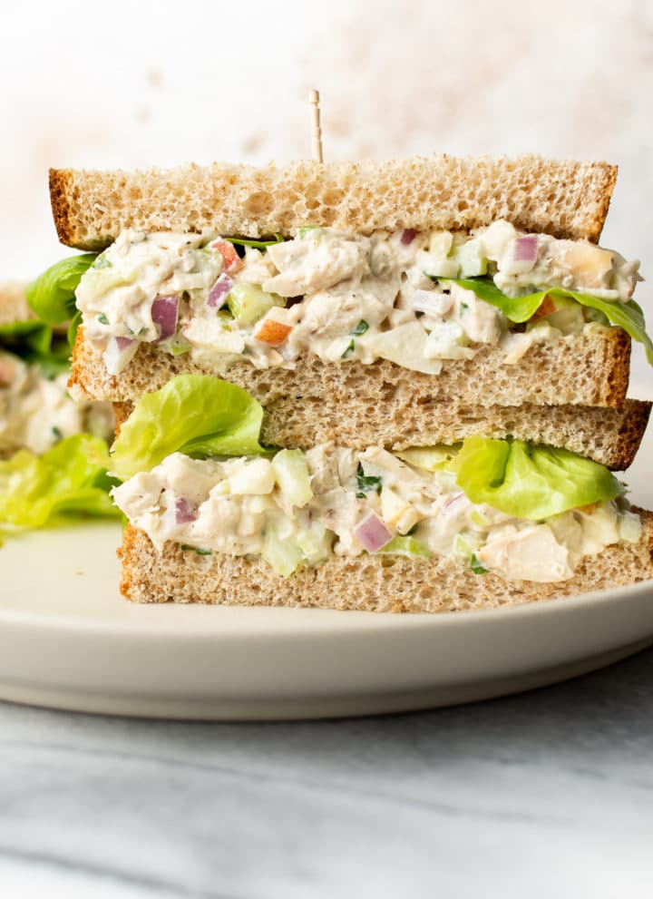 two classic chicken salad sandwiches stacked on top of each other