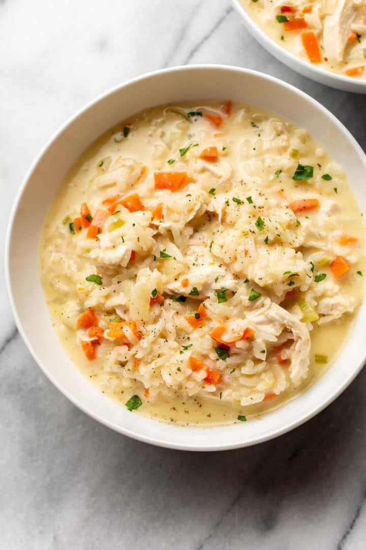 close-up of creamy chicken and rice soup in a white bowl