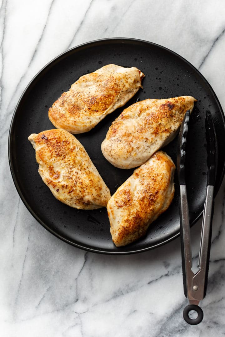 pan seared chicken breasts on a plate