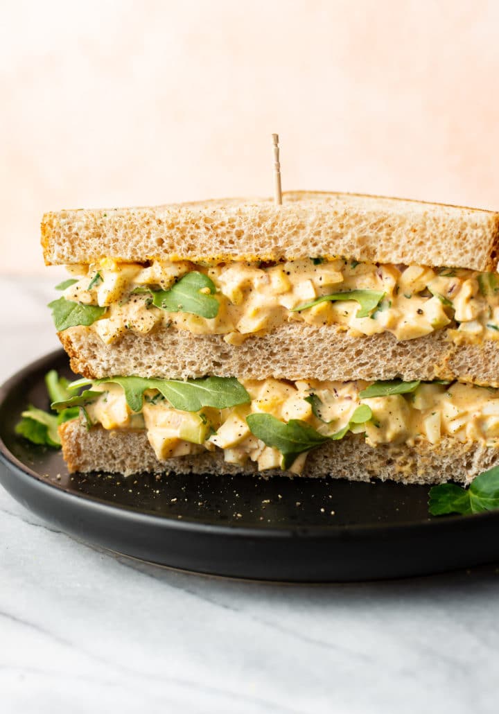 the best egg salad sandwich on a black plate