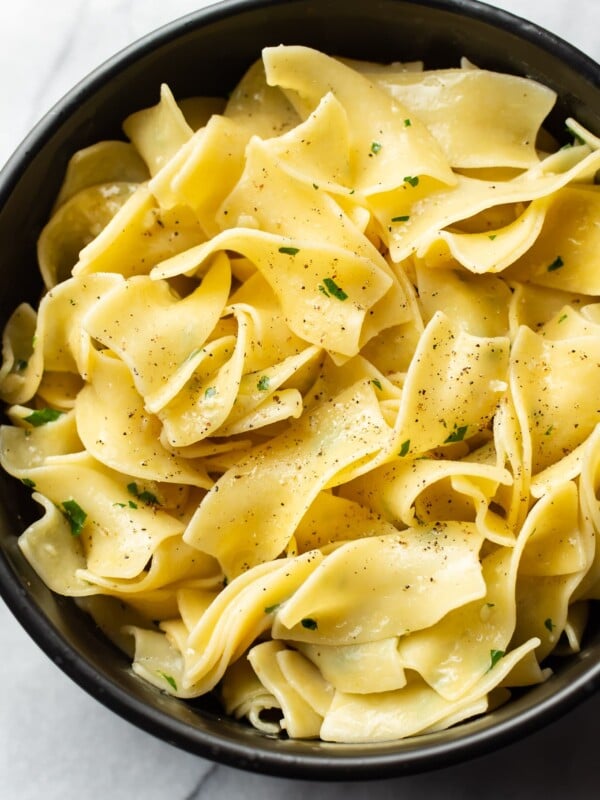 parmesan garlic butter noodles in a black bowl