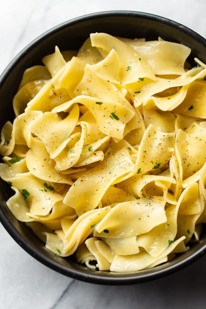 parmesan garlic butter noodles in a black bowl