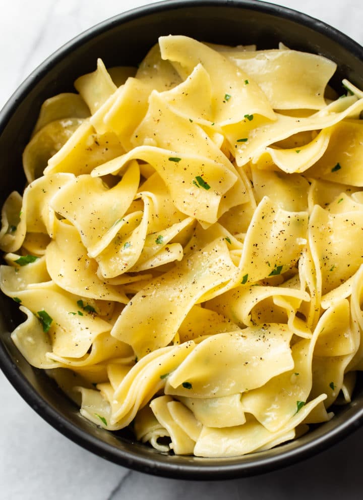 parmesan garlic butter noodles in a black bowl
