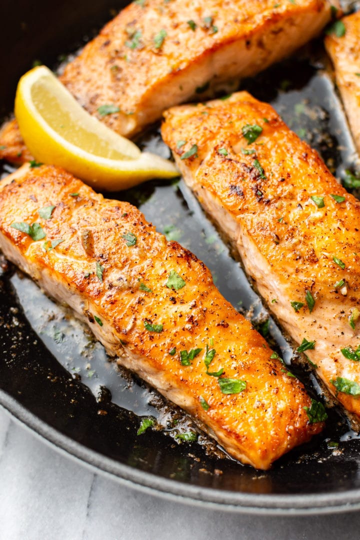 close-up of garlic butter salmon in a skillet