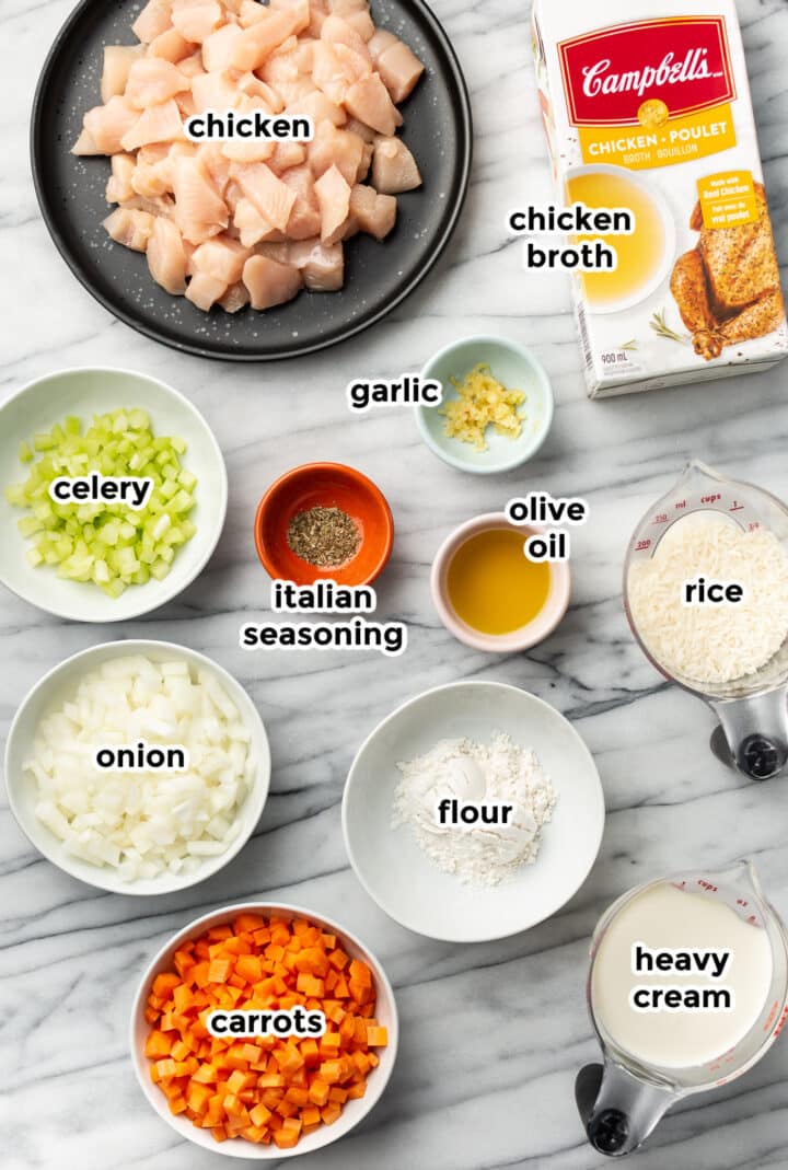 ingredients for creamy chicken and rice soup in prep bowls on a counter