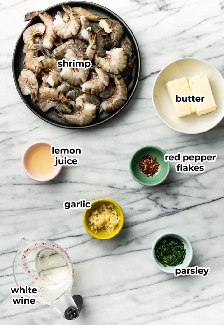 ingredients for shrimp scampi in prep bowls on a counter
