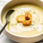 bowl of potato leek soup with a spoon