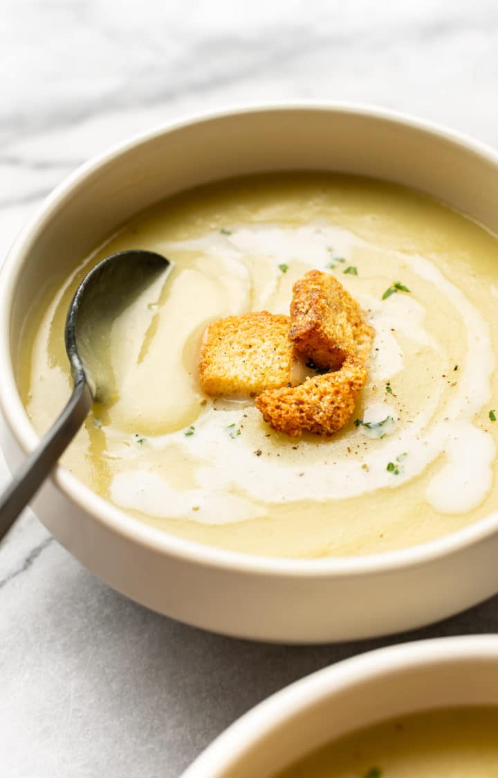 bowl of potato leek soup with a spoon