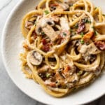 creamy bacon and mushroom pasta in a shallow bowl