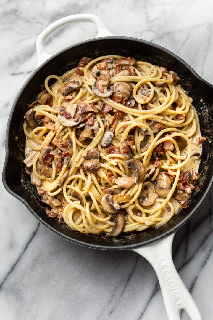 bacon and mushroom pasta in a skillet