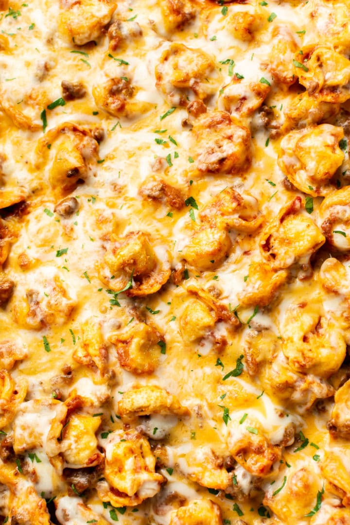 close-up of cheesy baked tortellini with meat sauce