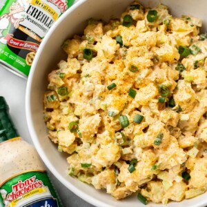 Creole ranch potato salad in a serving bowl with Tony Chachere's Original Creole Seasoning shaker container and Tony's Ranch Dressing bottle