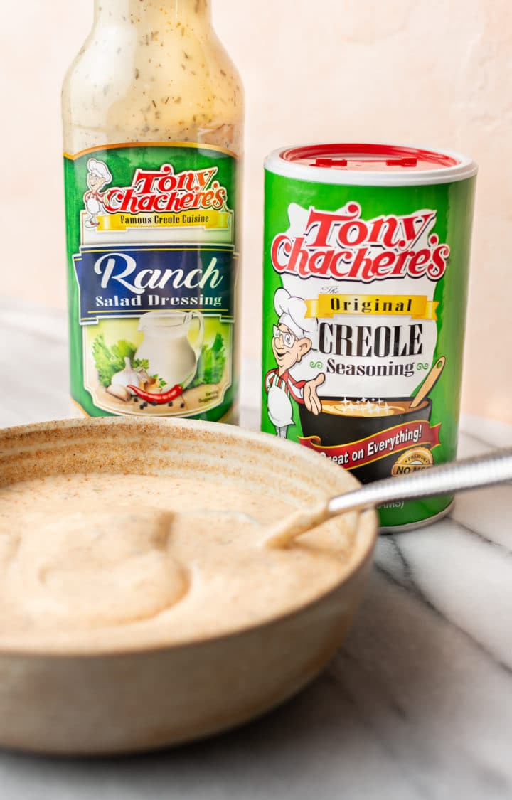 potato salad dressing in a small bowl with Tony Chachere's Original Creole Seasoning shaker and Tony's Ranch Dressing bottle