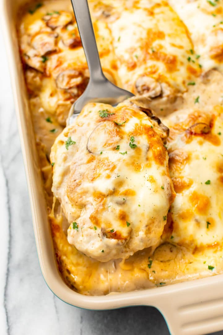 Chicken a la Gloria casserole (chicken being lifted by spatula)