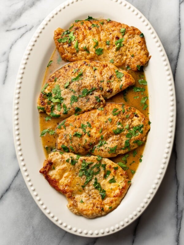 lemon chicken scallopini on a white platter