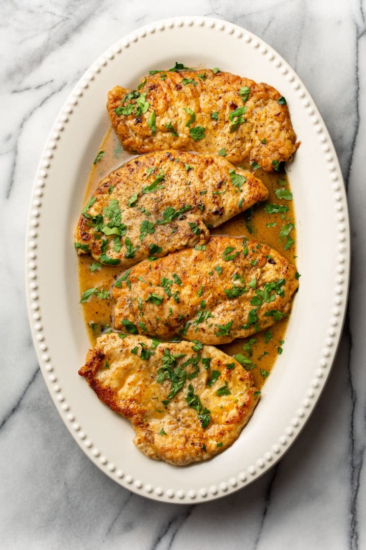 lemon chicken scallopini on a white platter