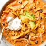 a bowl of creamy chicken tortilla soup with a spoon