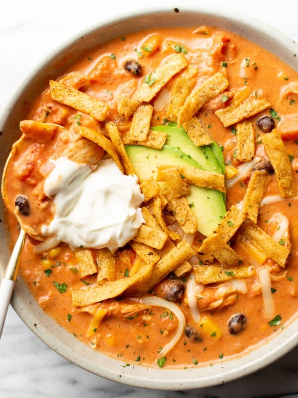 a bowl of creamy chicken tortilla soup with a spoon