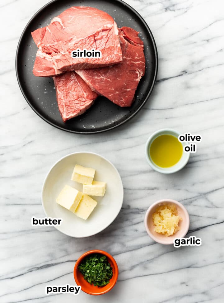 ingredients for garlic butter steak bites in prep bowls