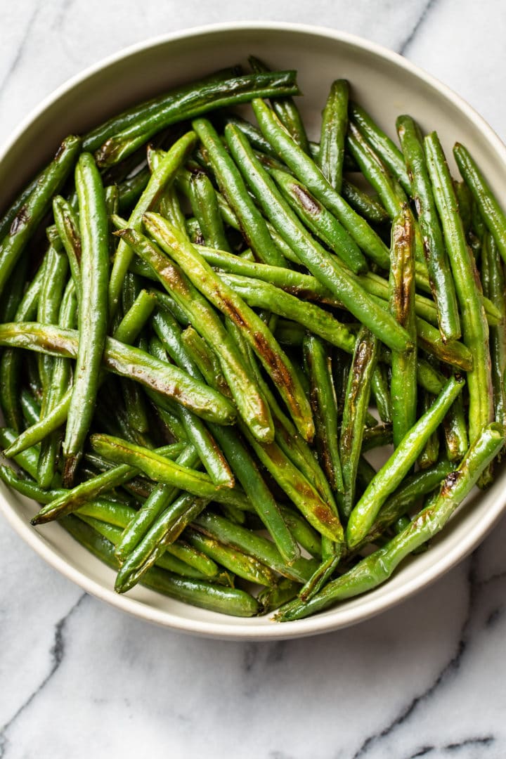 the best roasted green beans in a beige serving bowl