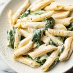close-up of creamy Boursin pasta with spinach in a shallow bowl