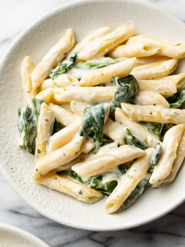 close-up of creamy Boursin pasta with spinach in a shallow bowl