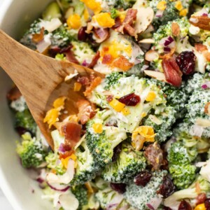 broccoli salad with wooden salad utensils