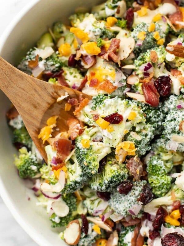 broccoli salad with wooden salad utensils