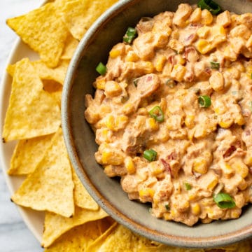 Rotel cream cheese corn dip in a bowl surrounded by tortilla chips