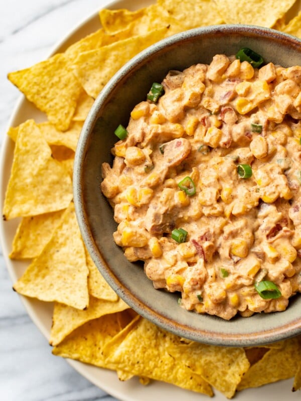 Rotel cream cheese corn dip in a bowl surrounded by tortilla chips