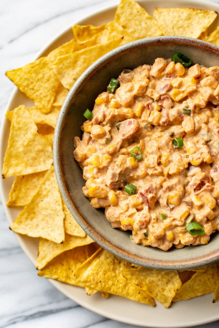 Rotel cream cheese corn dip in a bowl surrounded by tortilla chips