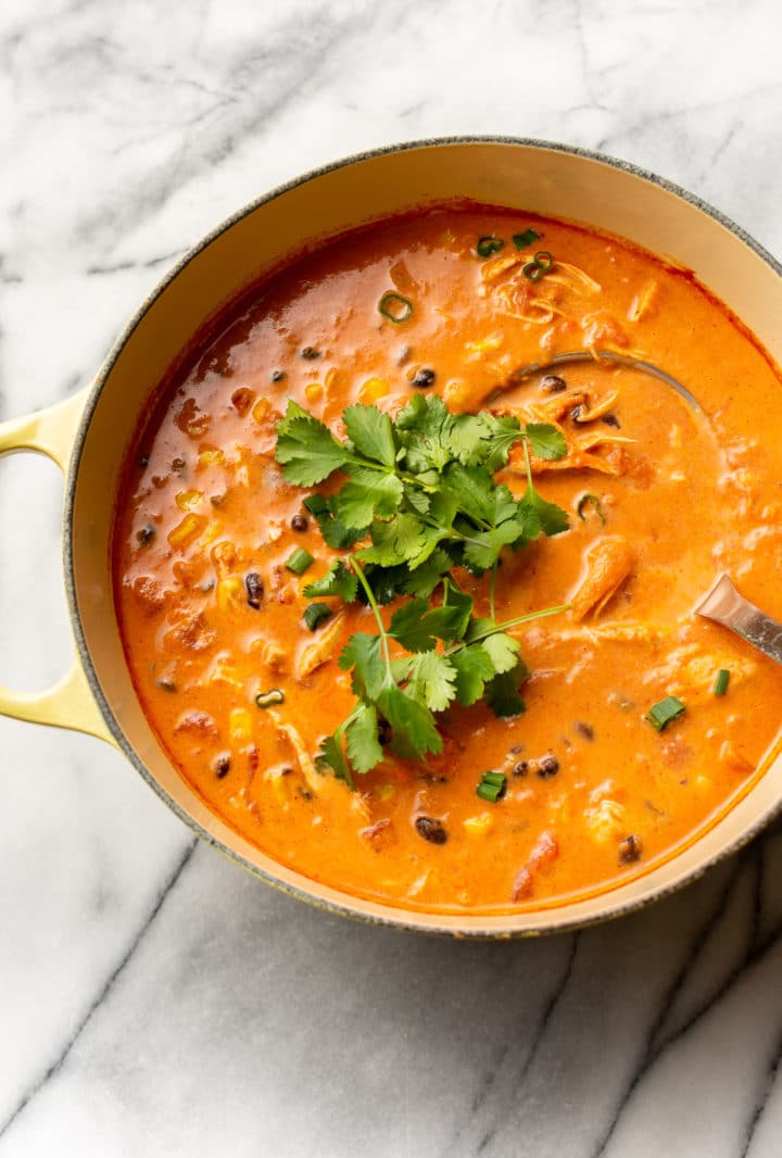 creamy chicken tortilla soup in a yellow pot