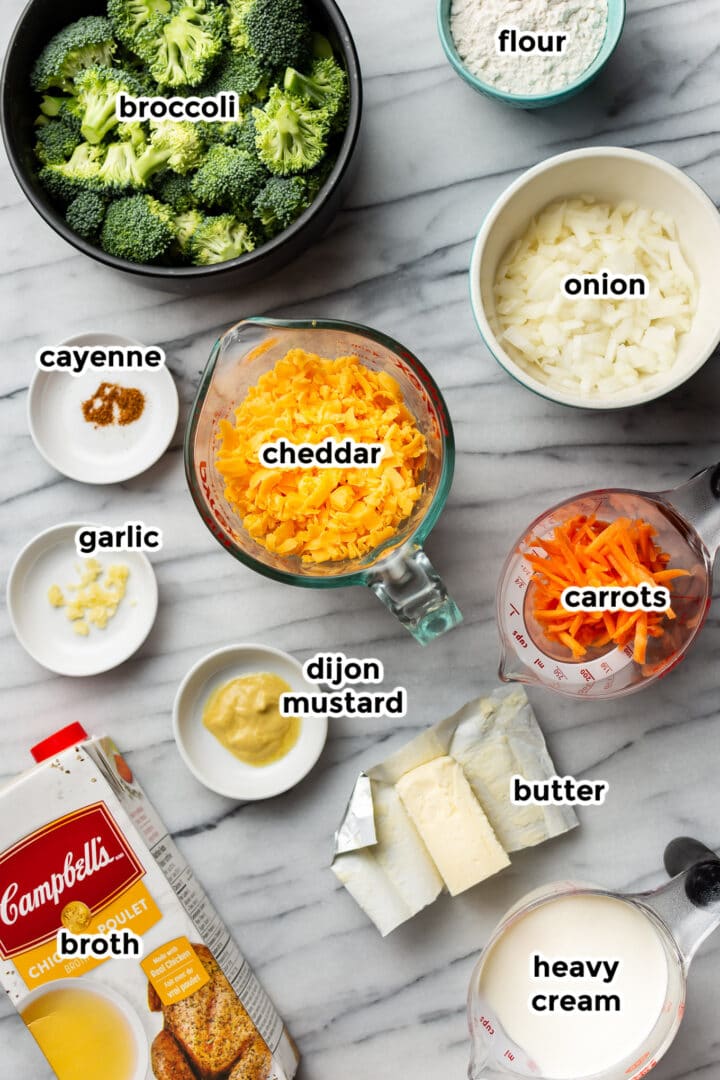 ingredients in small bowls on a marble counter for broccoli cheddar soup