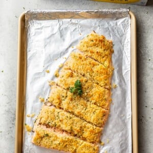 maple dijon baked salmon on a baking sheet with Reynolds Wrap foil in the background