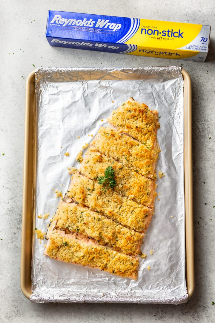 maple dijon baked salmon on a baking sheet with Reynolds Wrap foil in the background