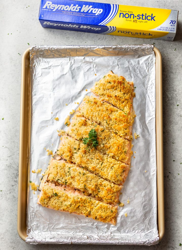 maple dijon baked salmon on a baking sheet with Reynolds Wrap foil in the background