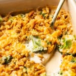 broccoli cheese casserole close-up with a spoonful being lifted out of casserole dish