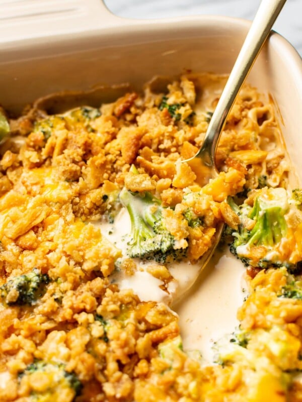 broccoli cheese casserole close-up with a spoonful being lifted out of casserole dish
