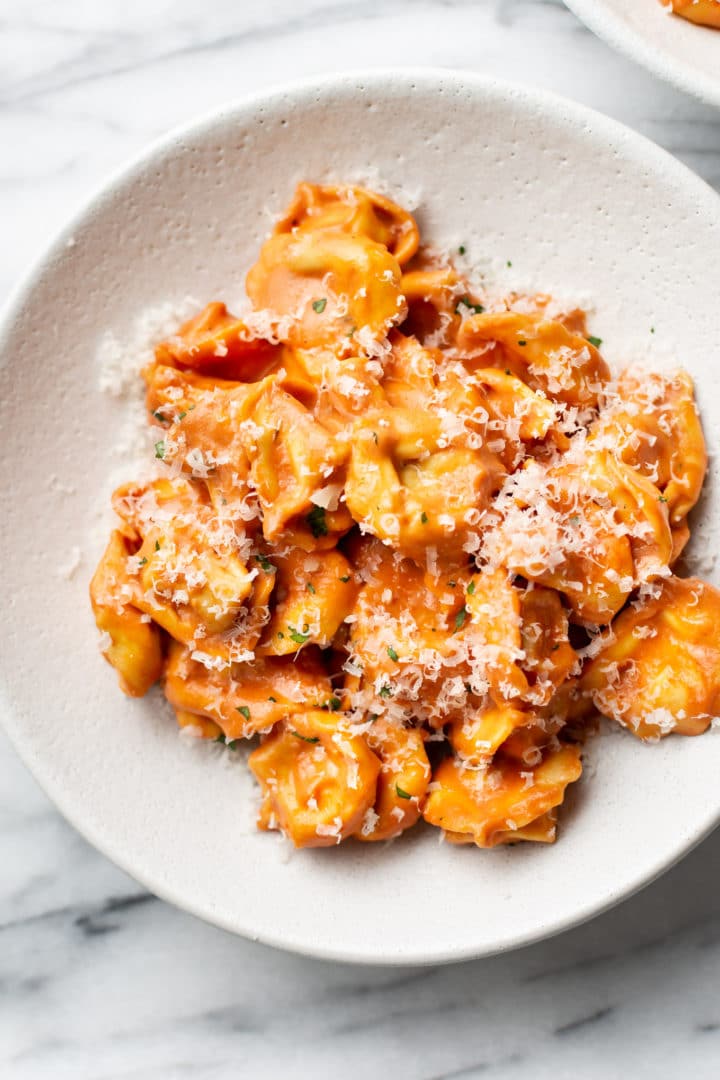 creamy tomato tortellini close-up in shallow bowl