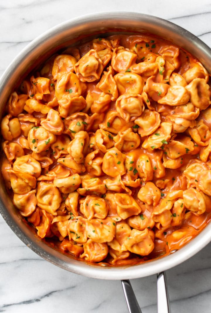 creamy tomato tortellini in a deep skillet