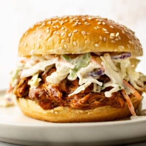 Crockpot BBQ chicken in a bun with coleslaw