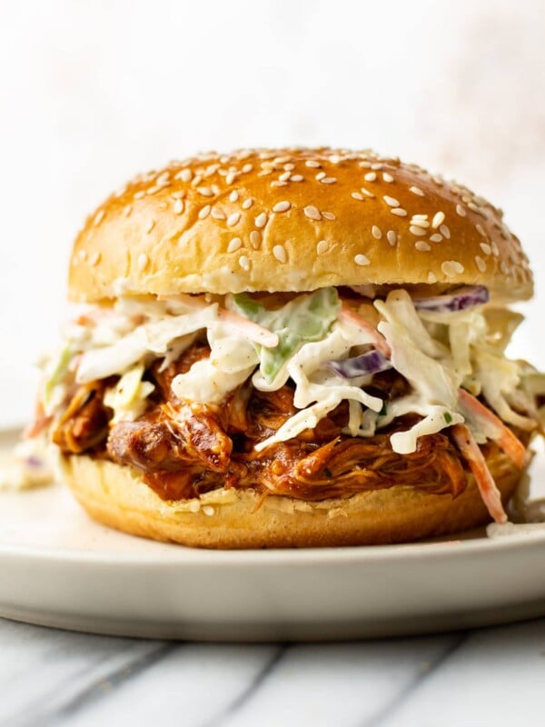 Crockpot BBQ chicken in a bun with coleslaw