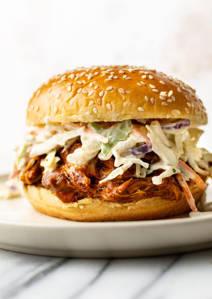 Crockpot BBQ chicken in a bun with coleslaw