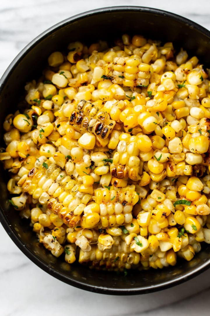 close-up of grilled corn kernels in a black bowl