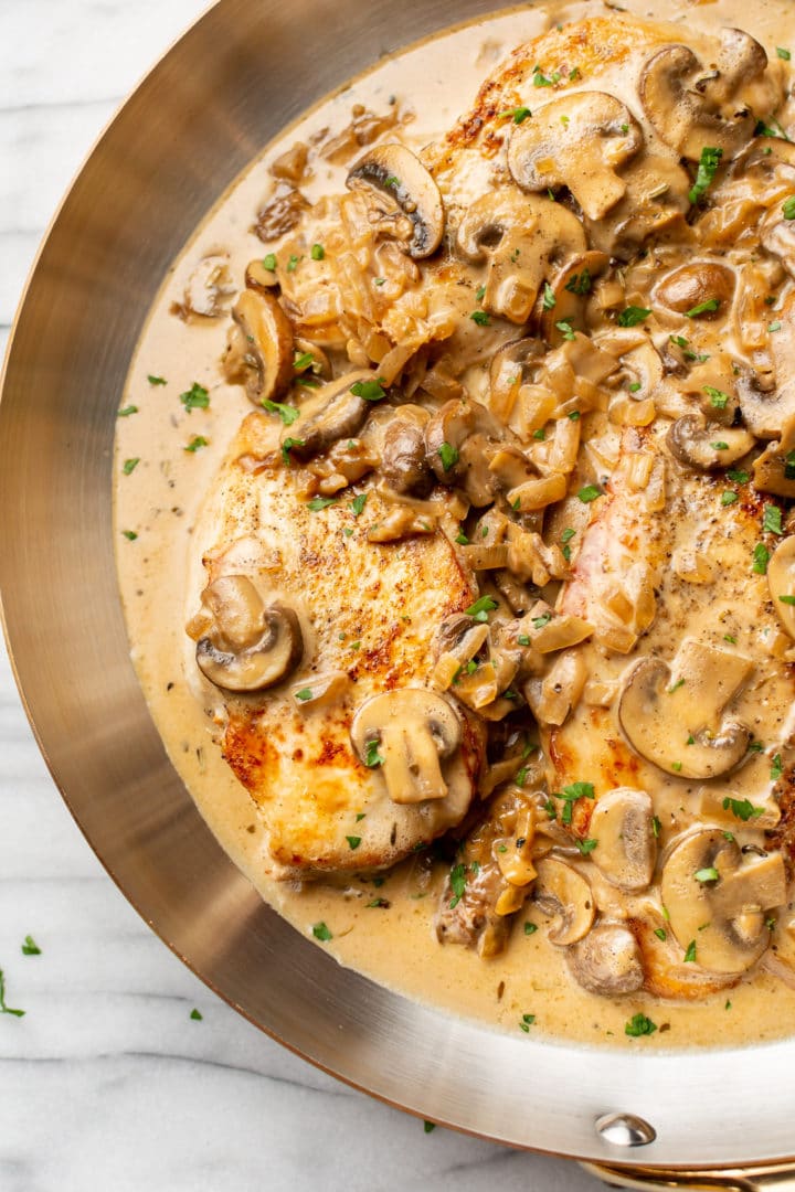 close-up of chicken with sherry cream sauce in a skillet