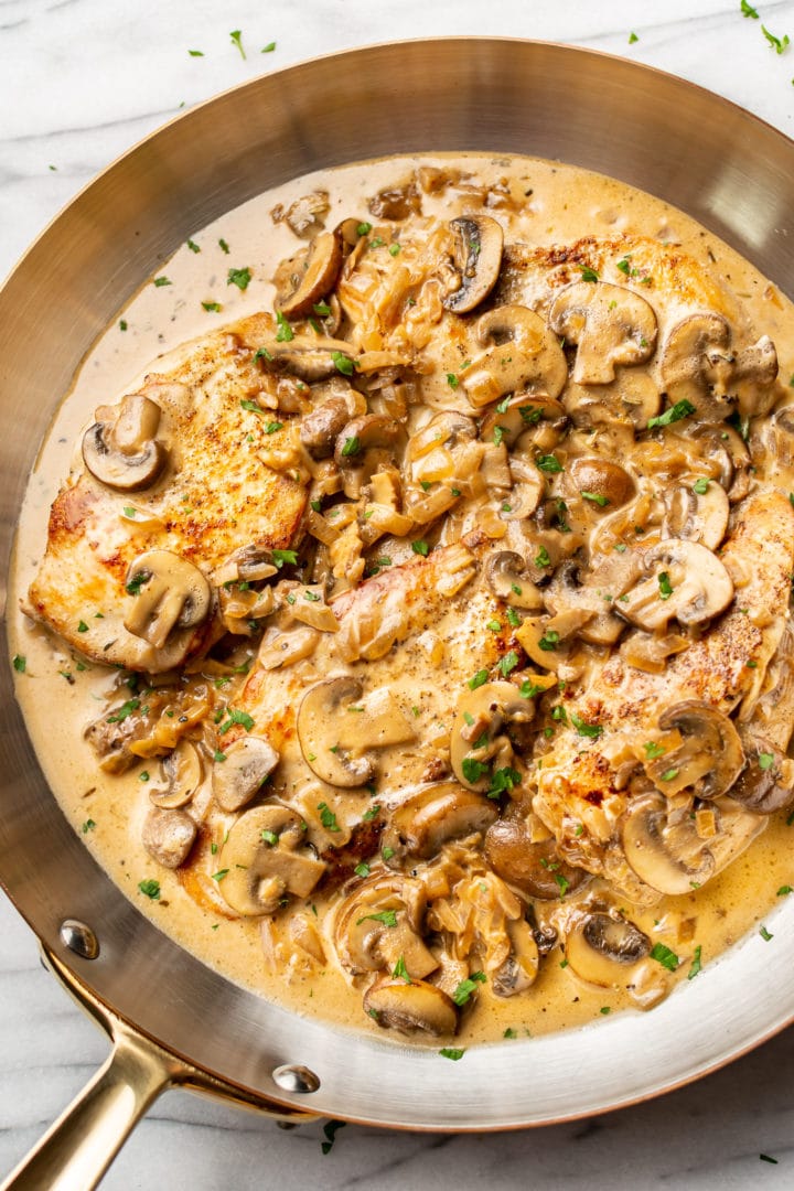 close-up of sherry chicken in a copper skillet