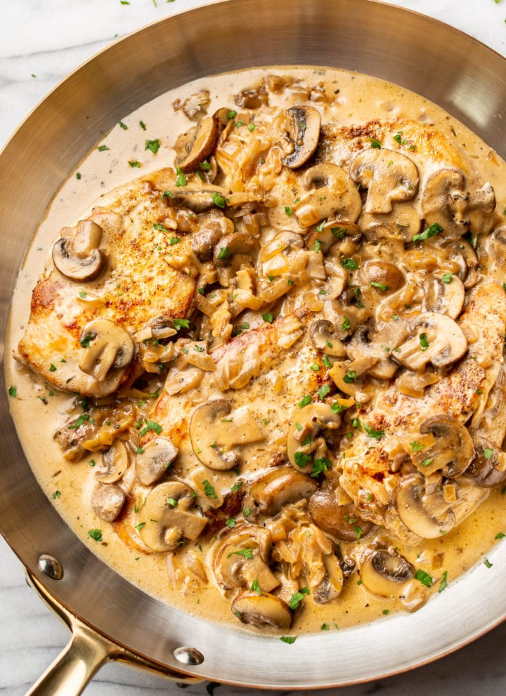 close-up of sherry chicken in a copper skillet